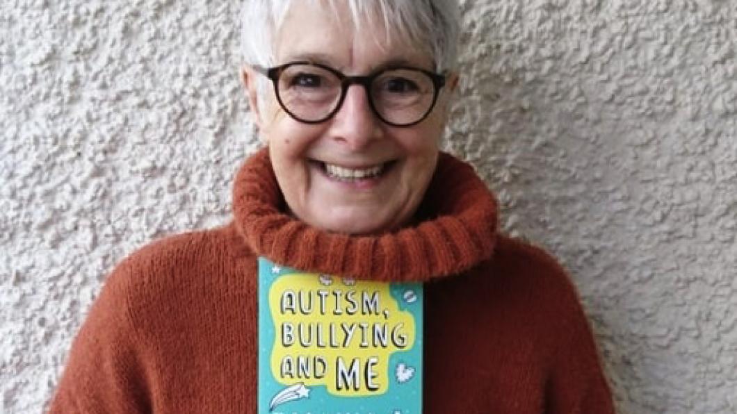 Woman with white hair holding book