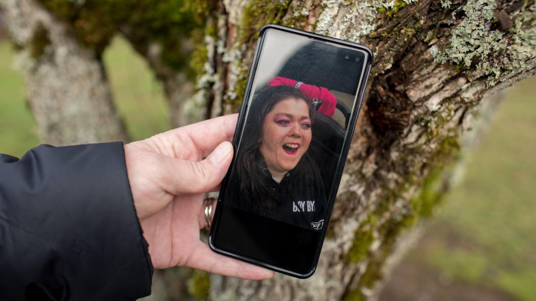 Cell phone with photo of smiling woman