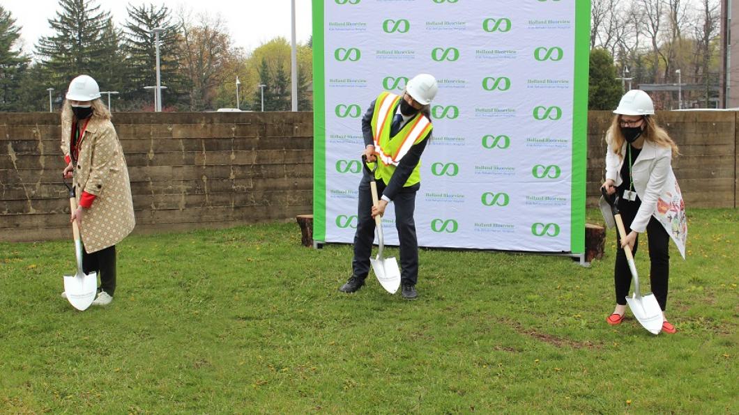 Hospital CEO Julia Hanigsberg poses with VP of Research Tom Chau and Foundation CEO Sandra Hawken for a shovel-in-the-ground photo on the site where the hospital's two-storey addition will be built this month.