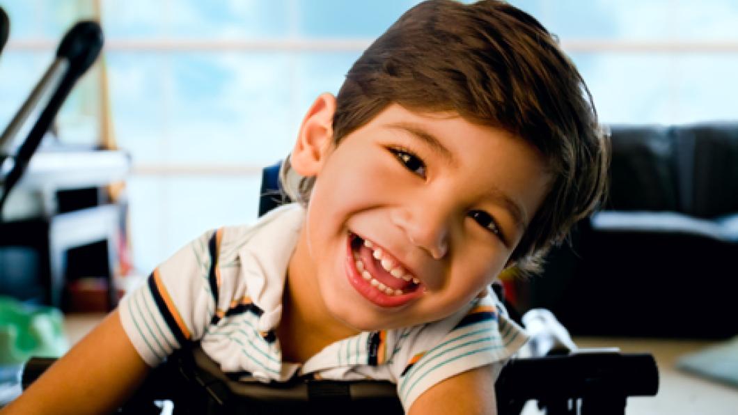 Smiling young boy in walker