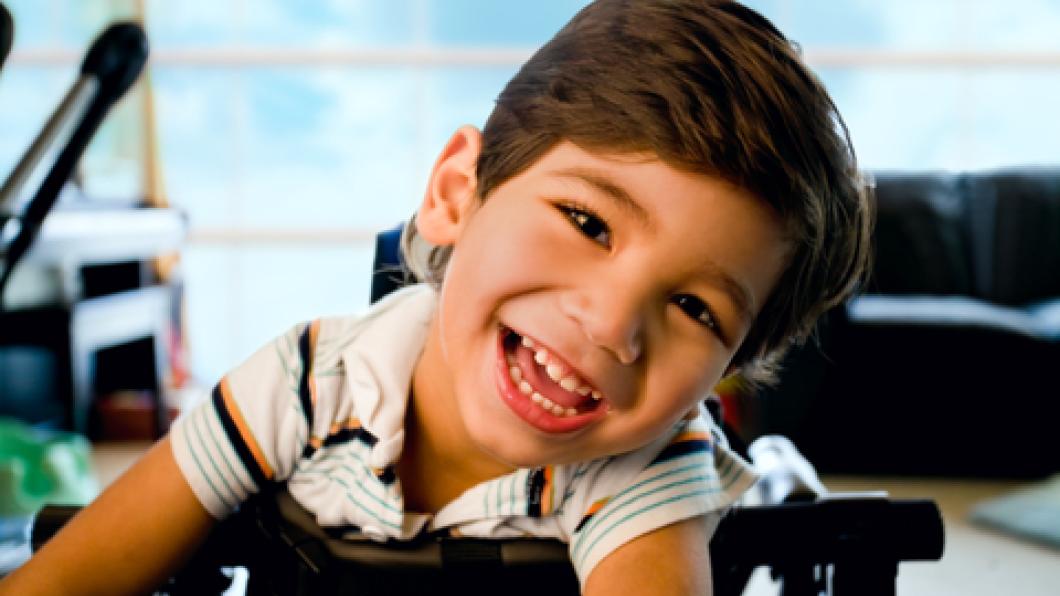 Boy with bright smile in stander