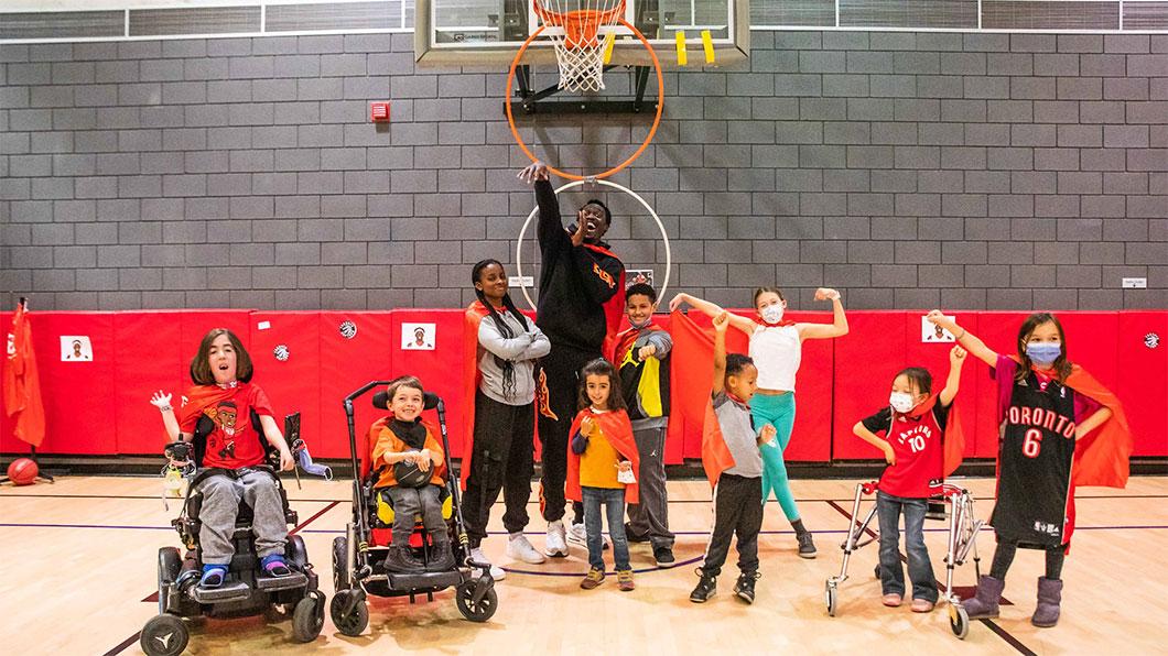 Pascal Siakam and Holland Bloorview kids in the gym playing basketball