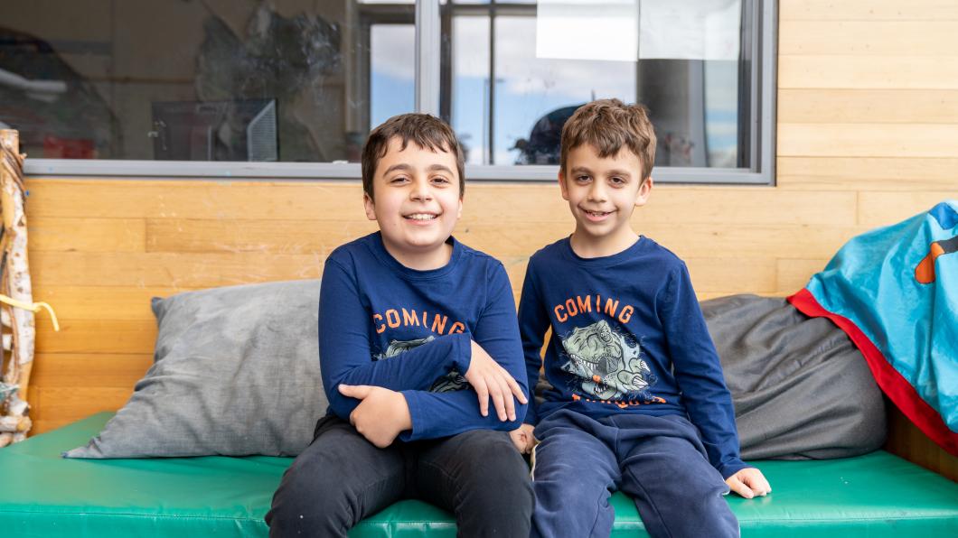 Norrin and his brother Alex sitting together on a bench.