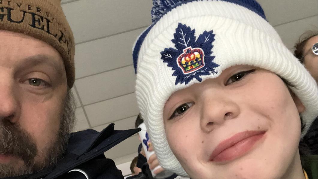 Selfie of boy in a tuque with a blue Maple Leaf and man in University of Guelph hat