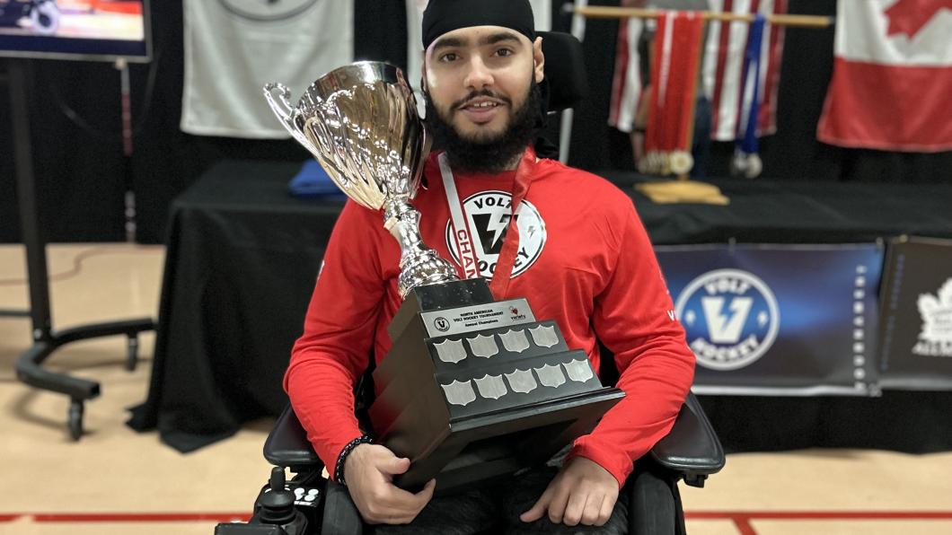 Bav holding a sporting trophy.