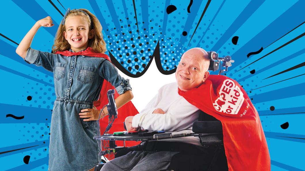 A child and an adult on wheelchair with red capes on