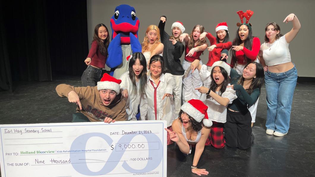 Earl Haig students posing with their oversized cheque to Holland Bloorview