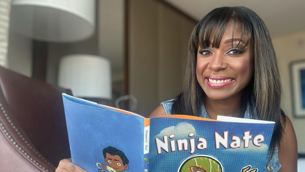 Woman holds children's picture book