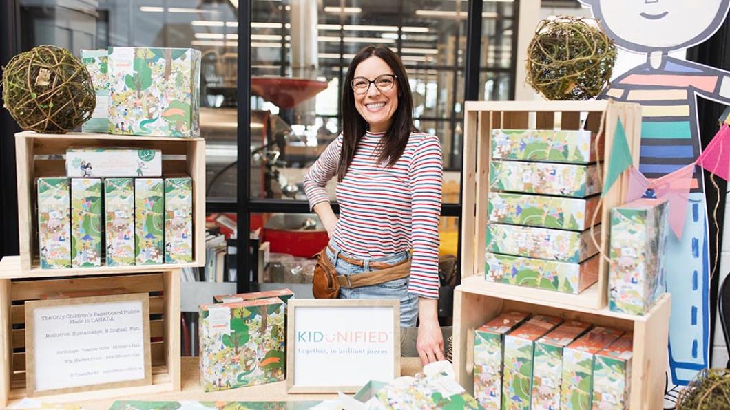 Woman with dark hair at table displaying children's puzzles