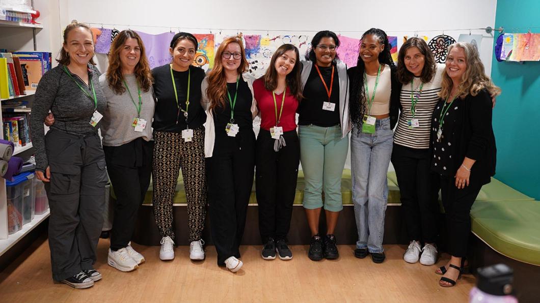 A group of people standing and having a photo together