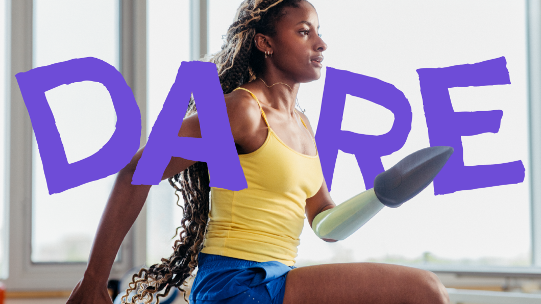 A young woman who uses a prosthetic arm running inside a gym