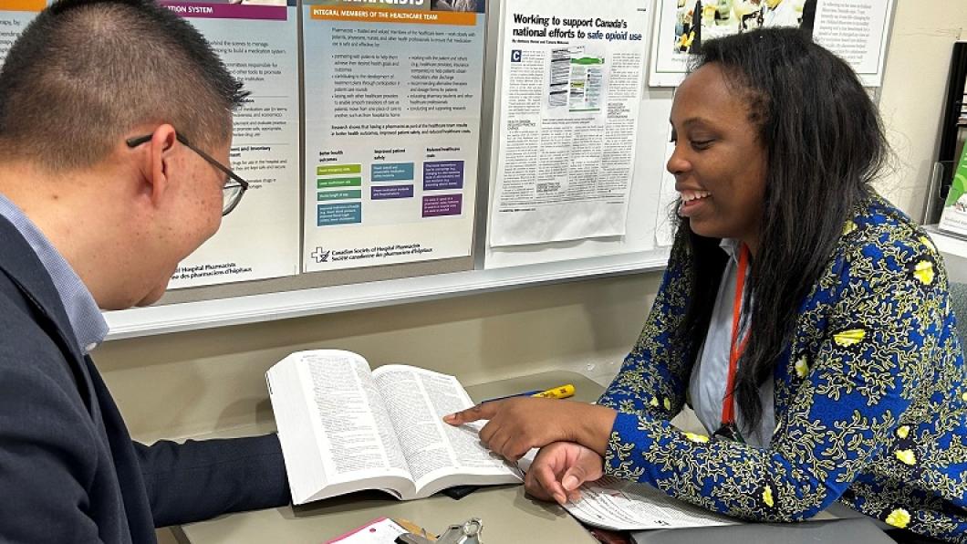 Nathan Ho, director of pharmacy and preceptor, chats with University of Toronto pharmacy student Olakemi Vilasa
