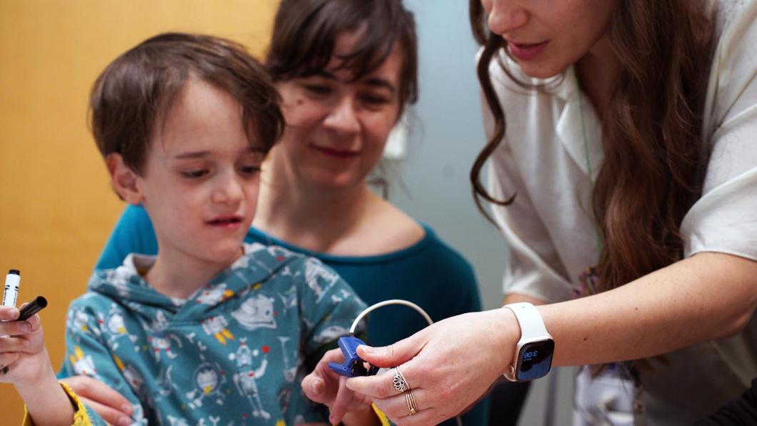 A child is having a test by clinical staff