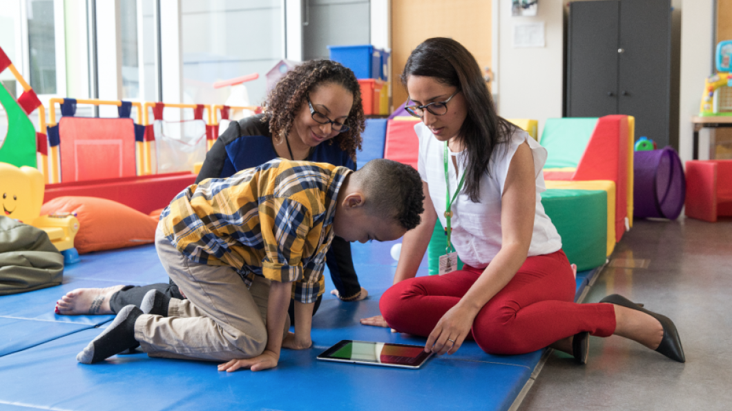 Two adults playing with a kid