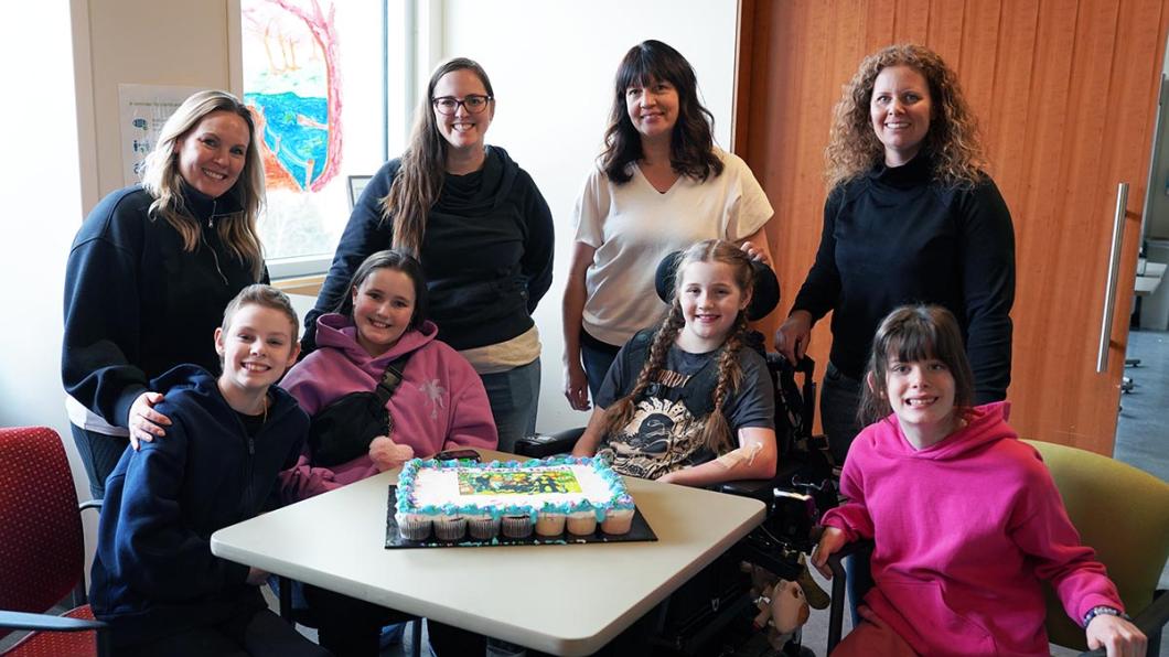 Holland Bloorview mothers Jenny, Jessica, Melissa and Allyson stand behind their daughters and inpatient clients Hannah, XX, Finnley and Scarlett who met during their time at the hospital. 
