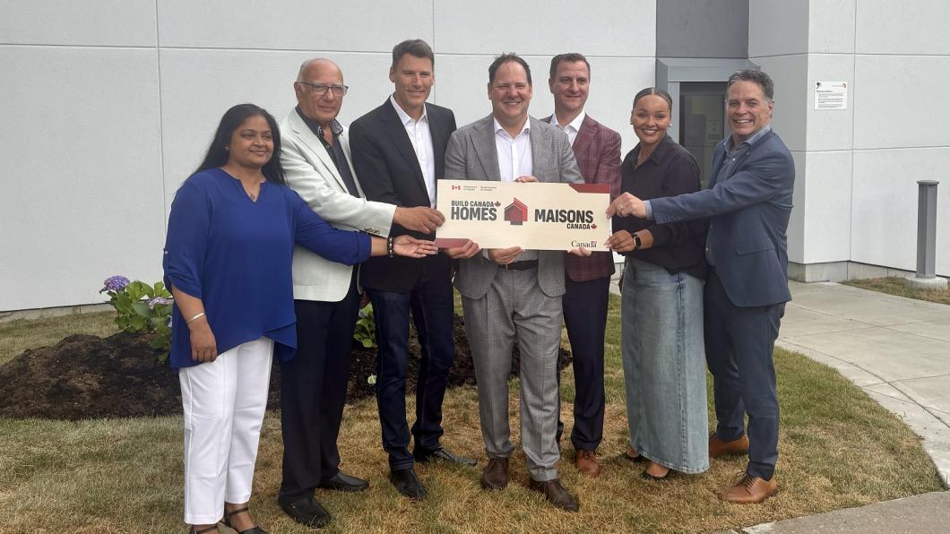 group of adults holding a sign during an announcement