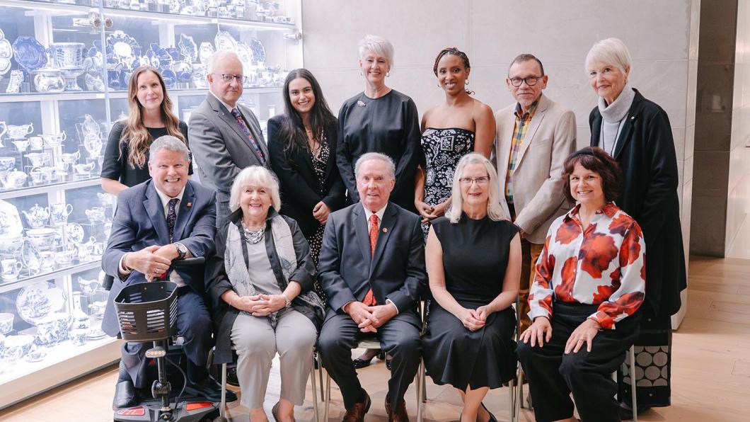 Dr. Peter Rumney (second from left, top row) and Zoe Garzouzi, chair of Holland Bloorview’s Youth Advisory Council (third from left, top row), pose with the 2026 Empowered Kids Ontario Tribute Award winners. Also pictured are EKO leadership and the evening’s host, the Honourable Jim Munson. 