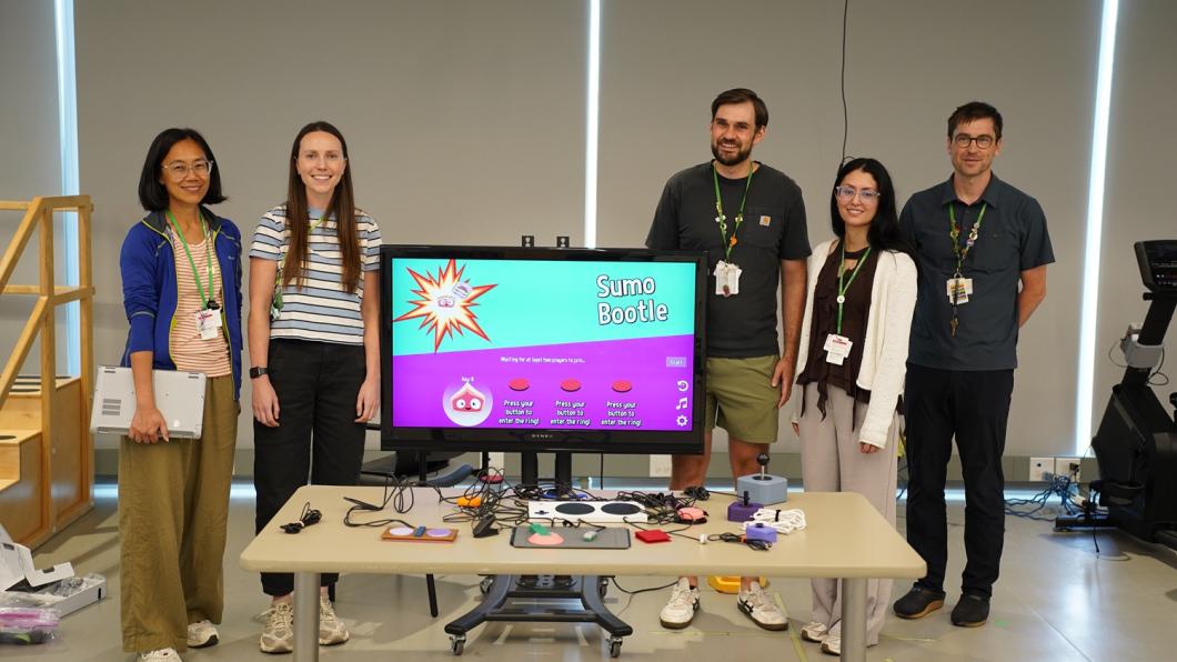 clinical team poses with adaptive gaming devices