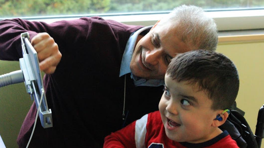 Man and boy looking at a tablet