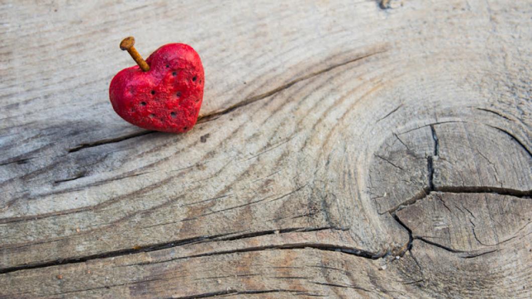 heart nailed into a piece of wood