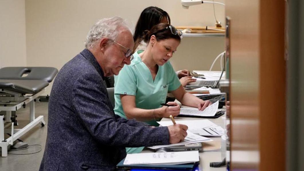 Dr. Peter Rumney reviewing charts with the Brain Injury Rehab team at Holland Bloorview, 2025.