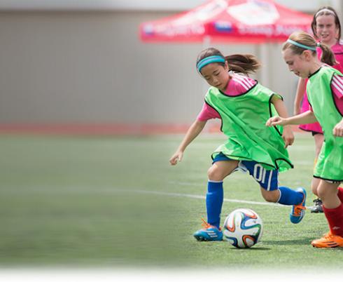 Soccer players running after the ball