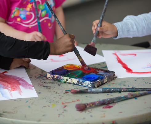 Close-up of kids painting. 