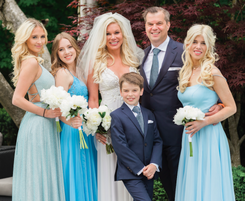 All six members of the Klein family pose for a photo, dressed in their wedding outfits.