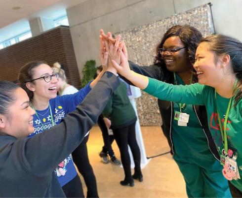 Image of staff and student high-fiving with Canada's Best Diversity Employer 2022 logo on left side of image