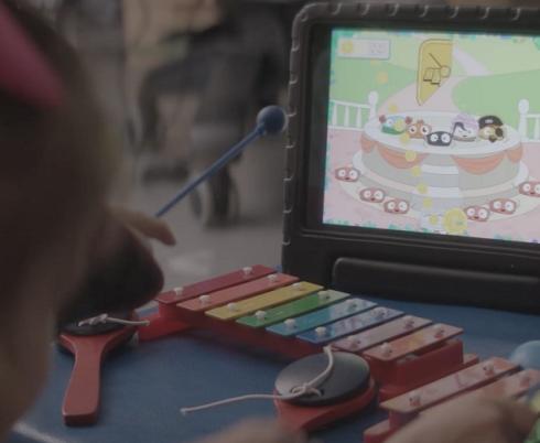girl playing Bootle Band video game at Bloorview Research Institute