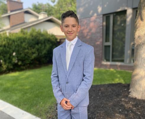 Carter standing in a suit.