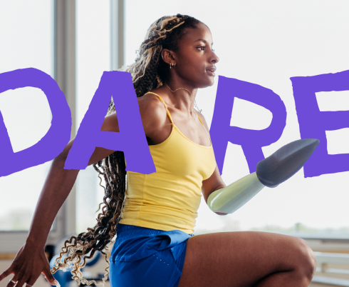 A young woman who uses a prosthetic arm running inside a gym