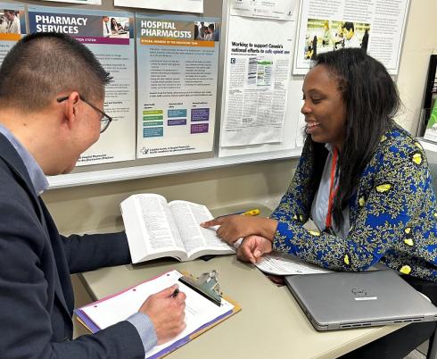 Nathan Ho, director of pharmacy and preceptor, chats with University of Toronto pharmacy student Olakemi Vilasa