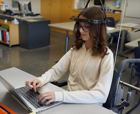 Teen sitting at a desk with her laptop open