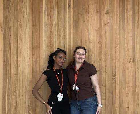 Two female students standing and posing for a photo