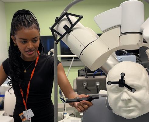 Female student demonstrates the transcranial magnetic stimulation technology