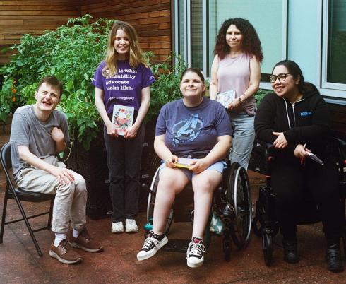 Five adults in an outdoor setting for a group photo